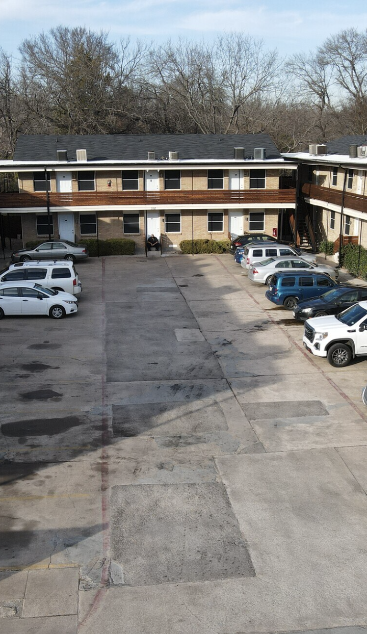an aerial view of a parking lot with cars at The Hampton Gardens